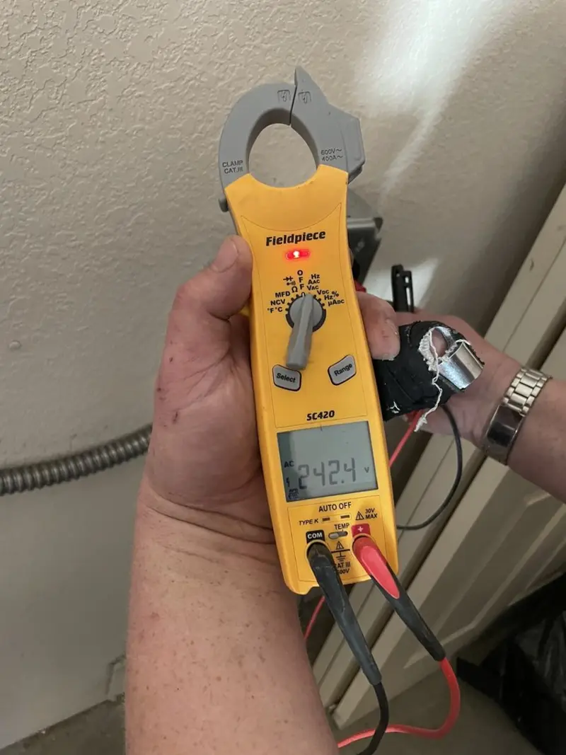 Voltage testing with clamp meter during Whole House Surge Protector in Thomson